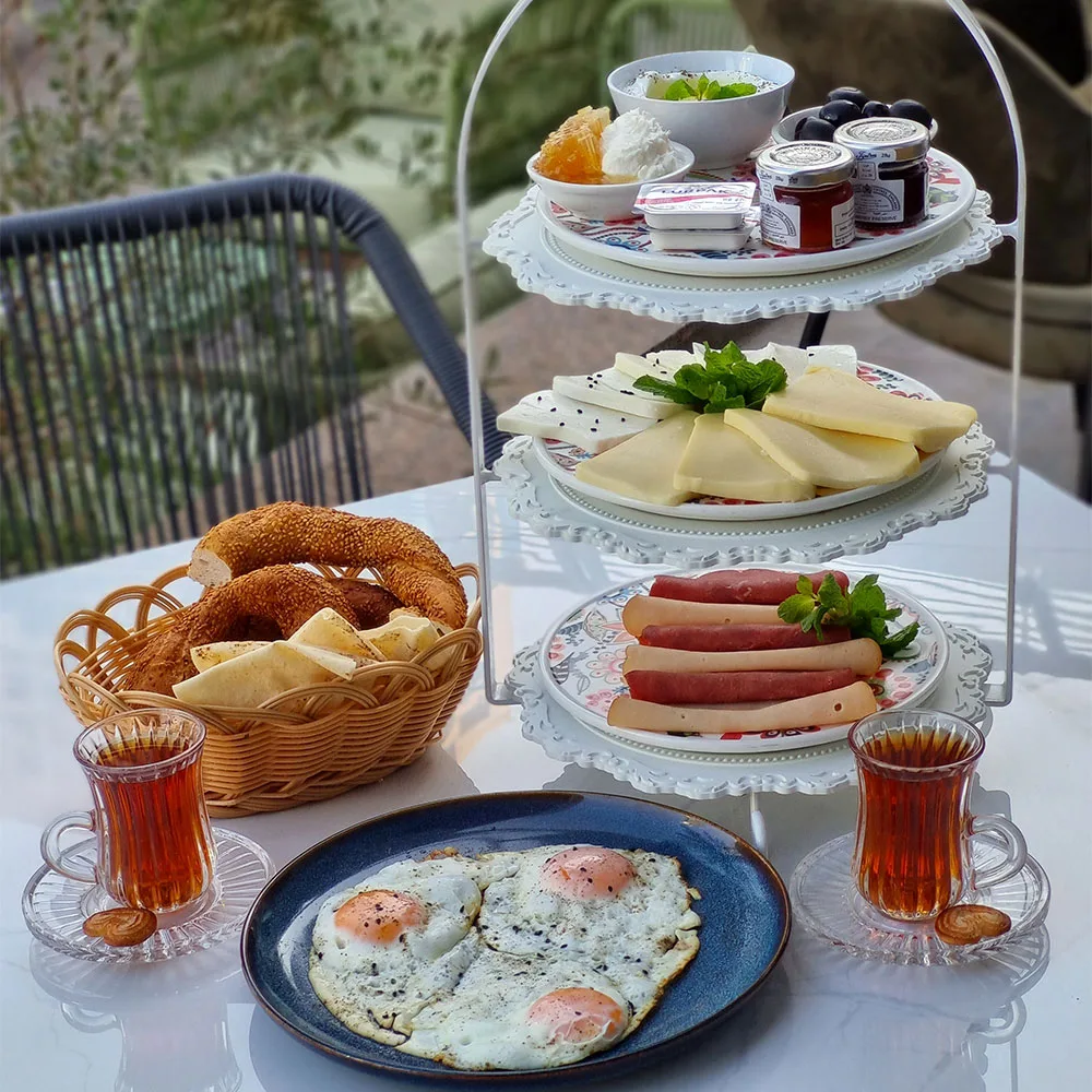 Turkish-style breakfast spread with cheeses, eggs and tea served on tiered platters