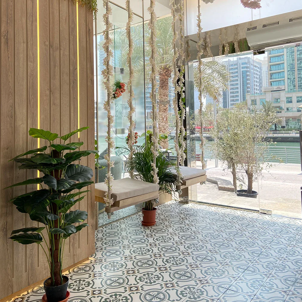 Café entrance with swing seats and greenery