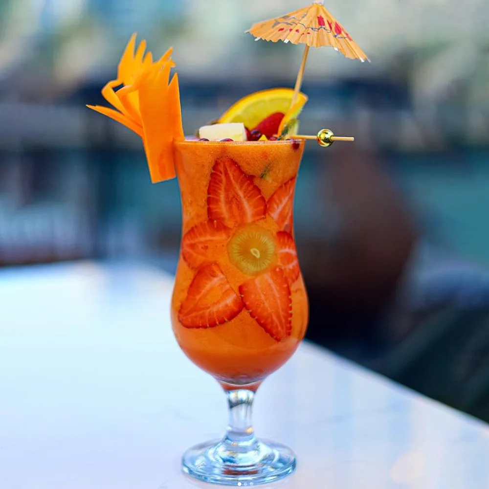Colourful fresh fruit mocktail garnished with fruit