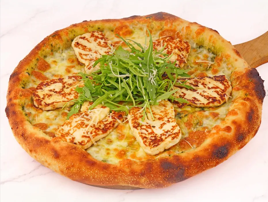 Wood-fired pizza topped with greens