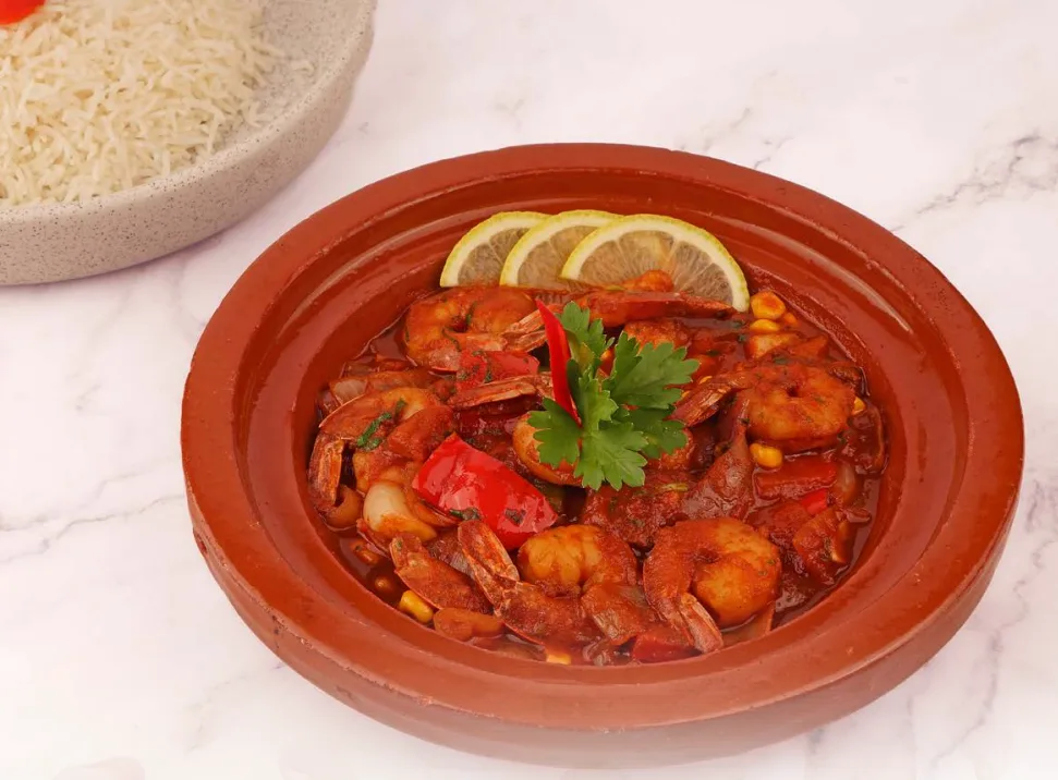 Shrimp tagine served in a terracotta dish
