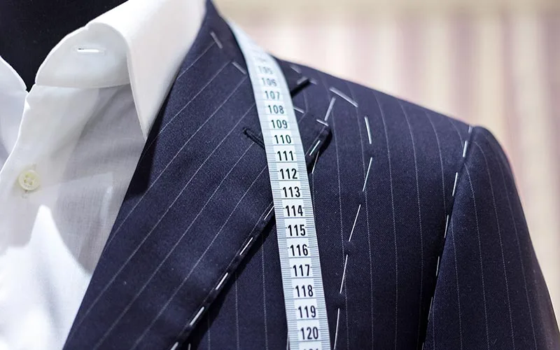 A bespoke pinstripe garment under construction with tailor's tacks