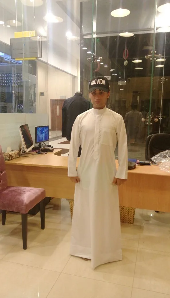 A man in a crisp white tailored kandura at the shop