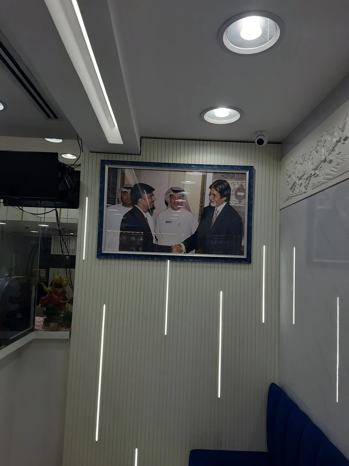 Framed photographs on the showroom wall above the seating area