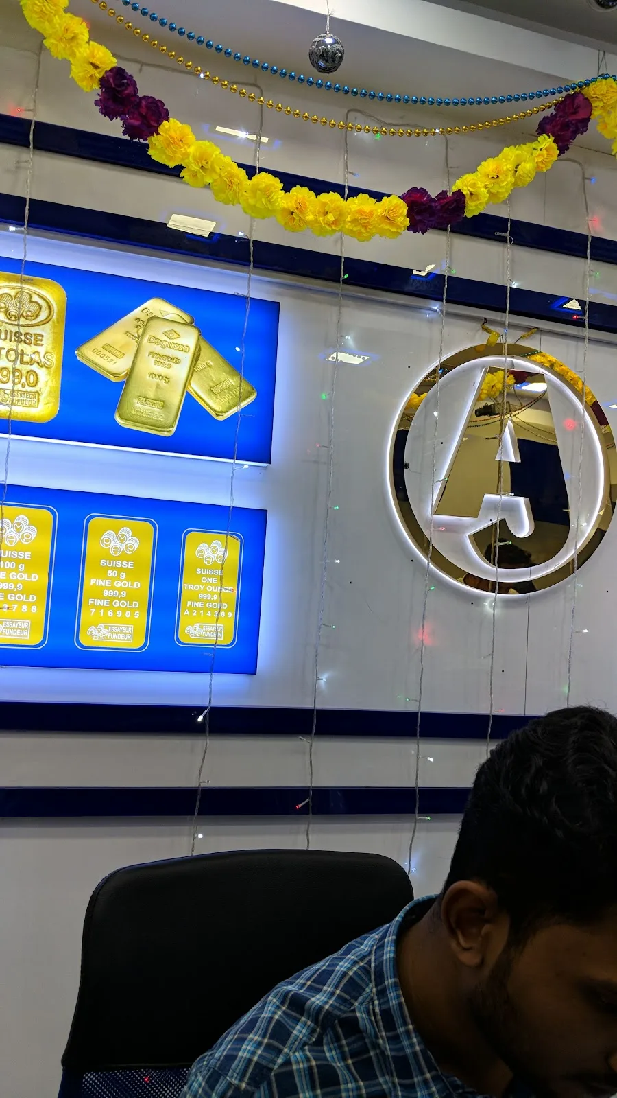 Festively decorated showroom interior with gold bars and floral garlands