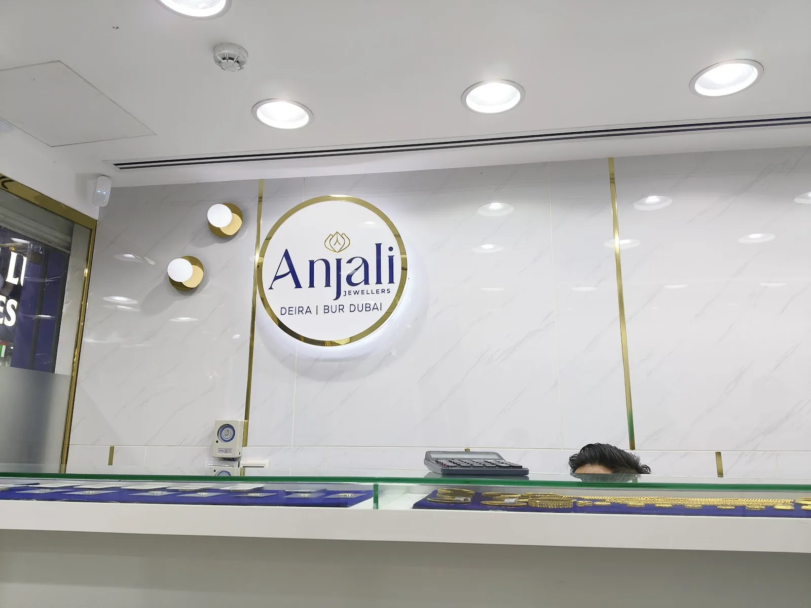 Interior of the Anjali showroom with gold display counter and seating
