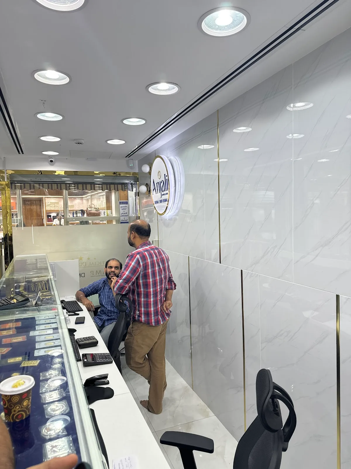 Staff assisting a customer at the Anjali Jewellers counter