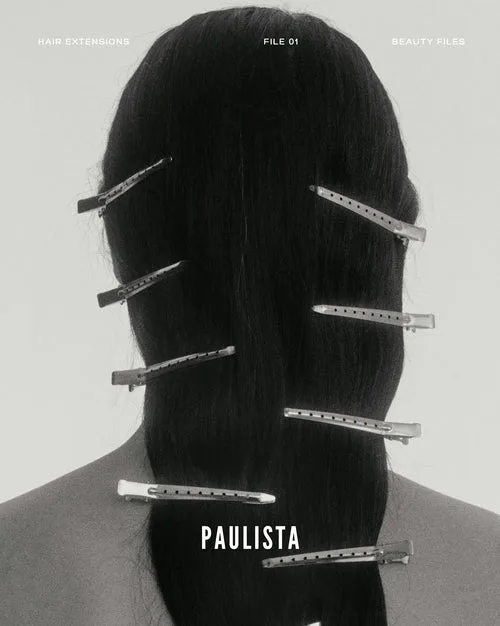 Editorial black-and-white image of hair sectioned with clips