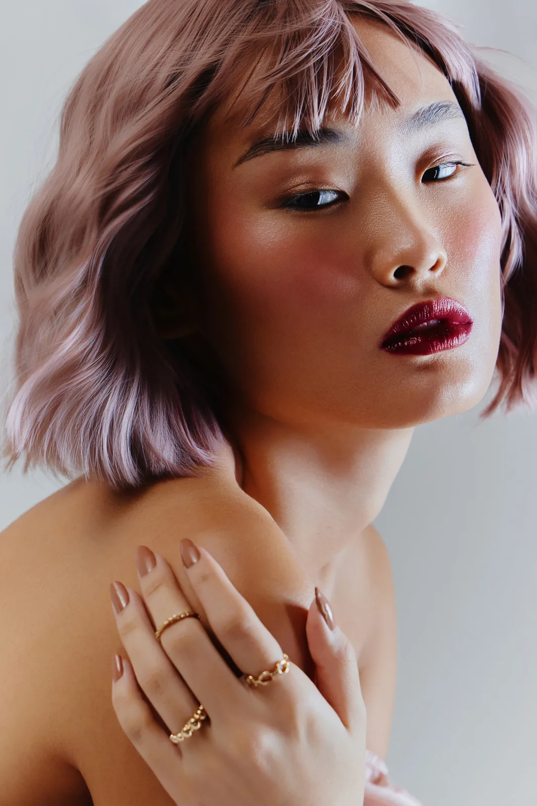 Editorial portrait of a model with rose-toned hair