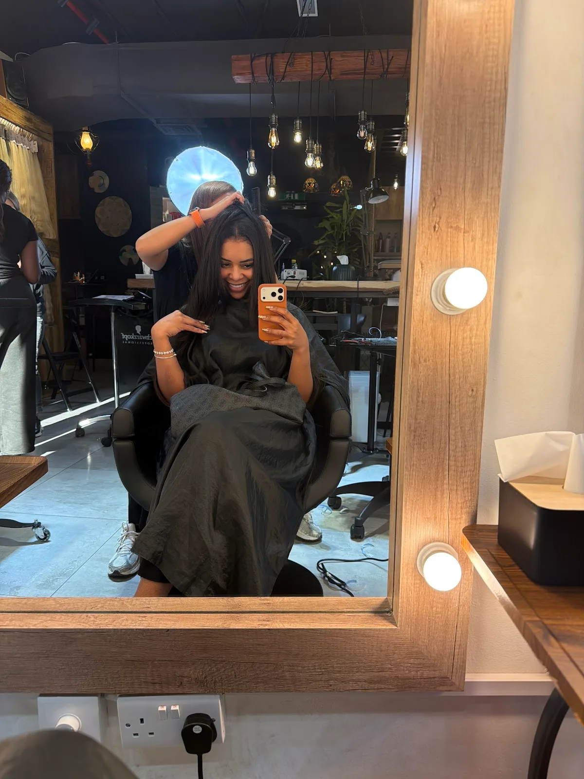 Smiling client in the salon mirror