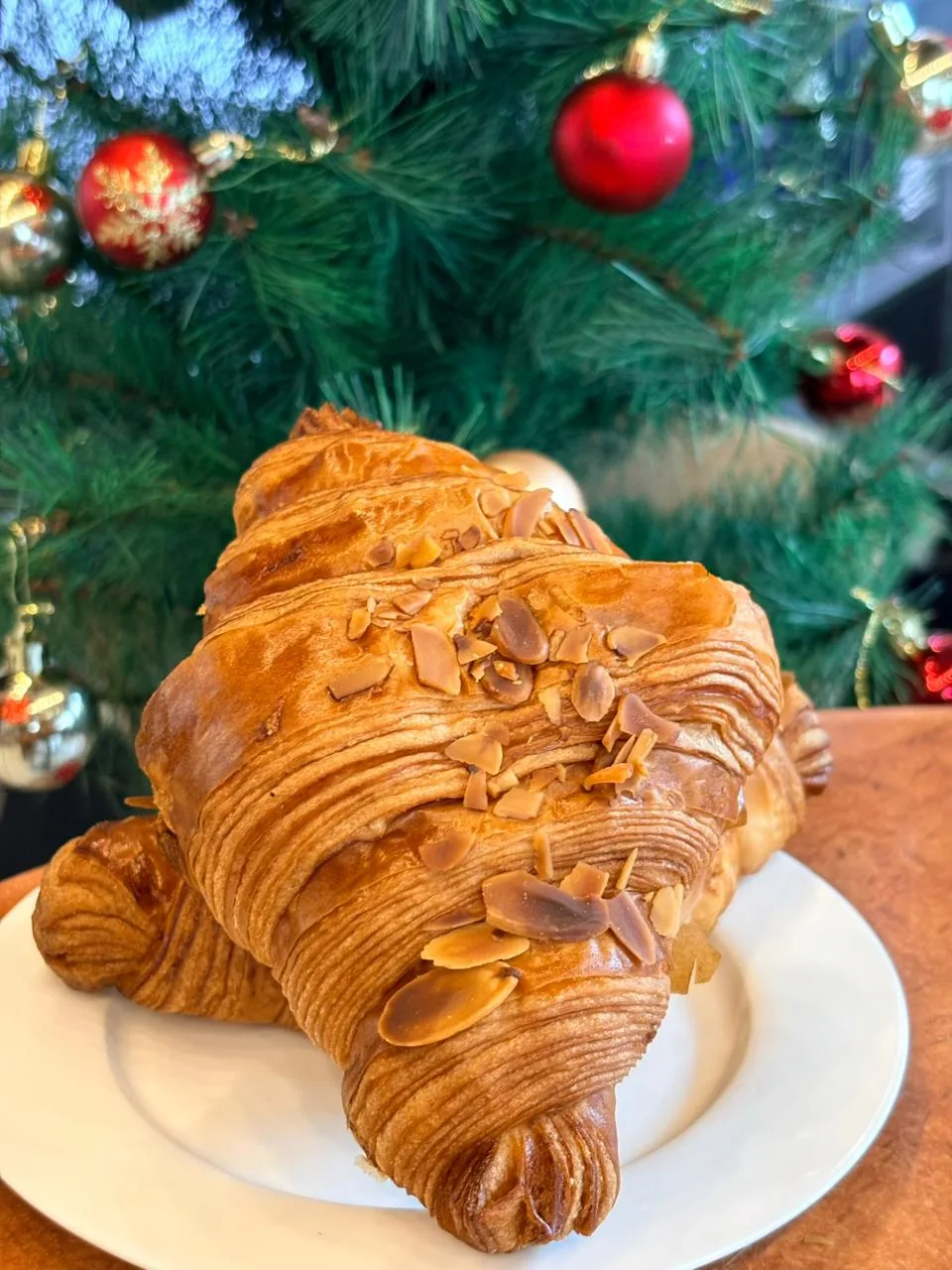 An almond croissant dusted with flaked almonds