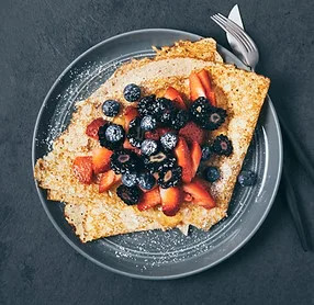 A crepe topped with fresh berries