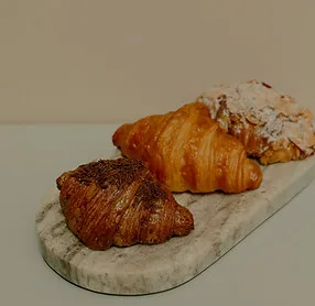 Fresh croissants on a marble board