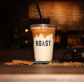 An iced Roast coffee in a clear cup