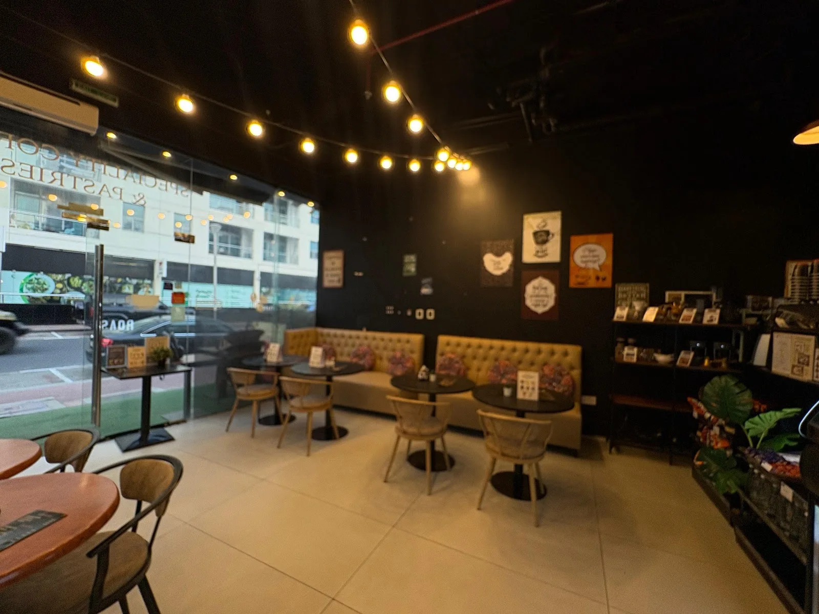 The café interior with string lights and banquette seating