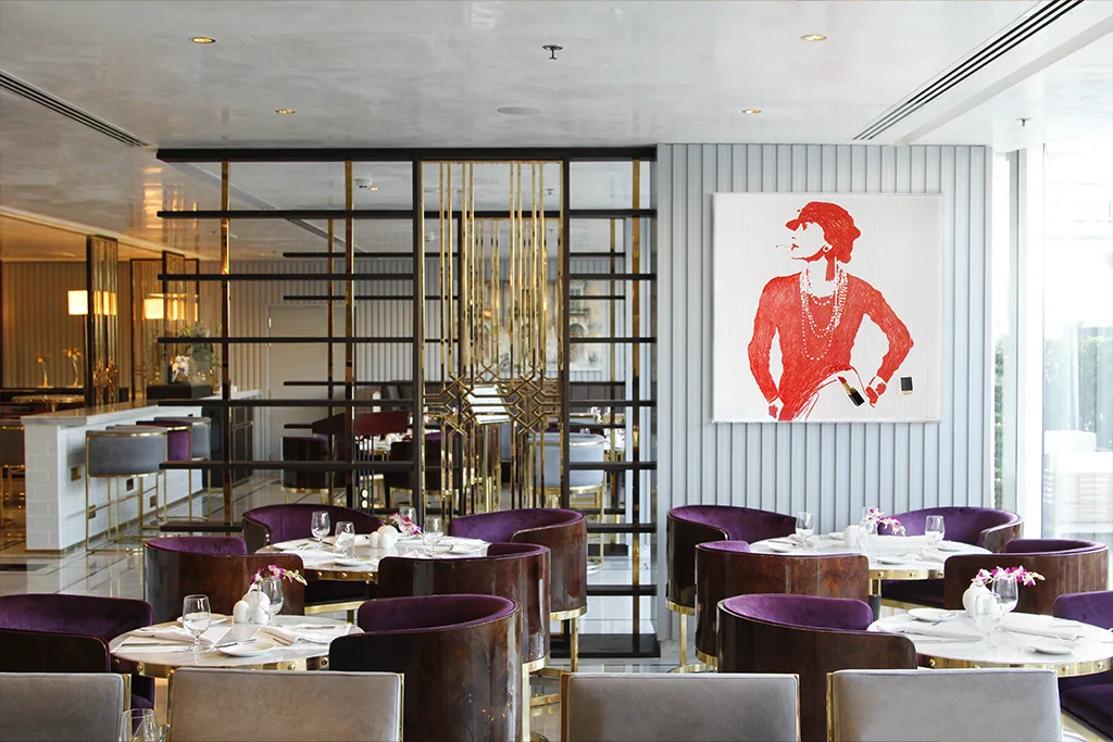Café Society storefront on Dubai Marina with a host at the entrance
