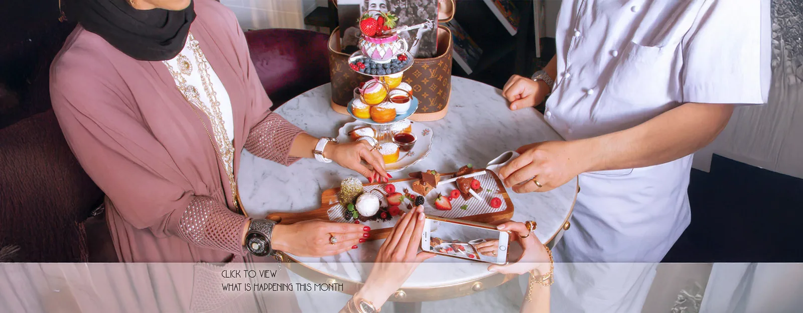 Tiered afternoon tea stand with savouries, scones and pastries