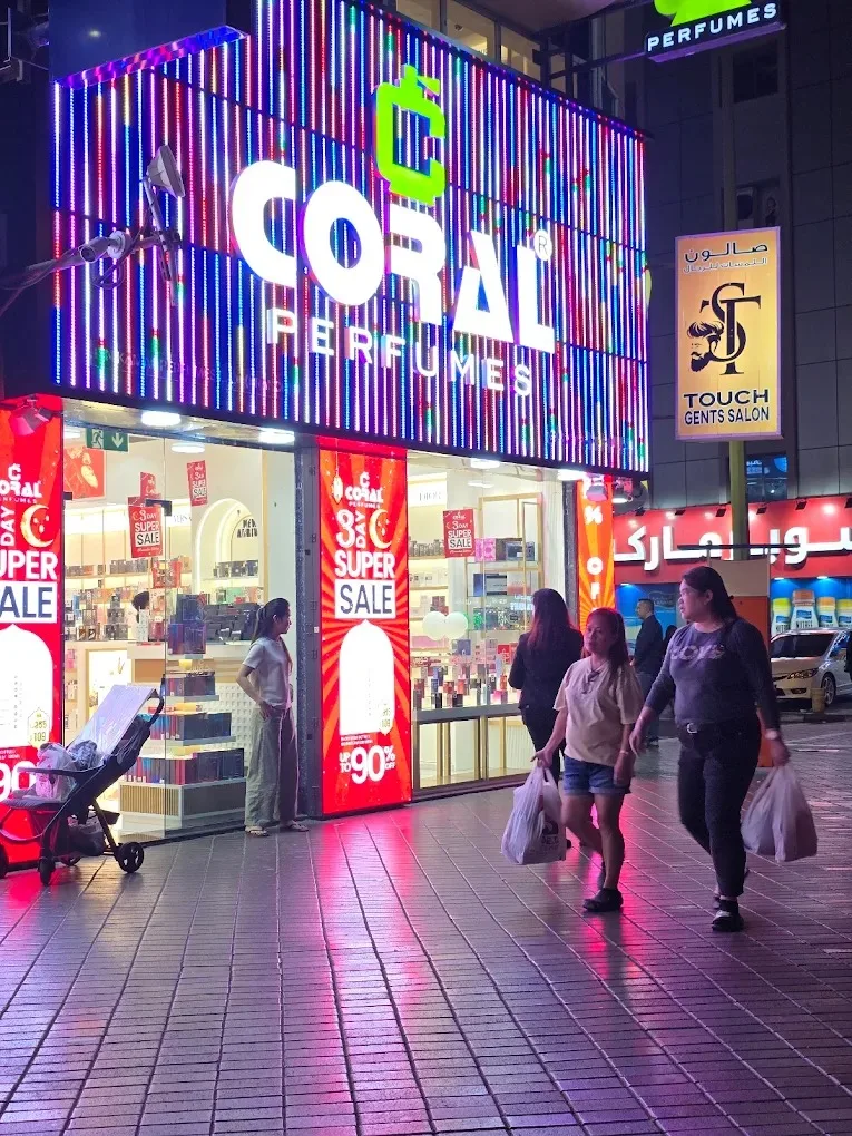 Coral Perfumes neon storefront at night