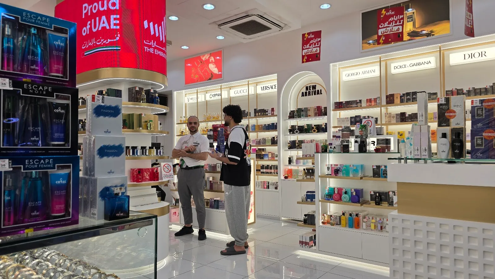 Team member helping a customer at Coral Perfumes