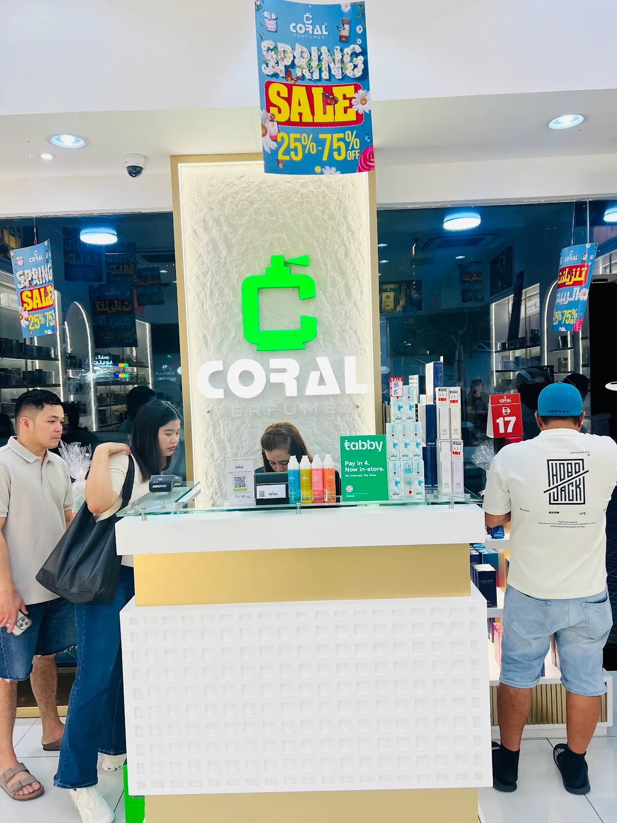 Customers at the Coral Perfumes counter during a sale