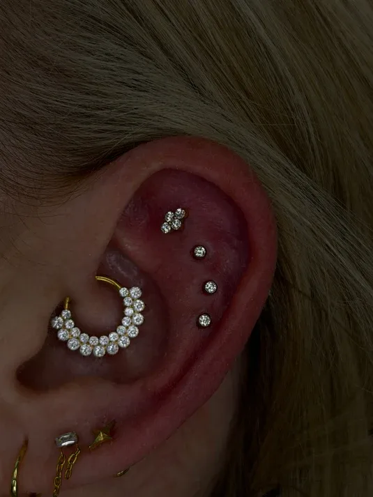 Gold daith piercing set with a crystal pavé hoop