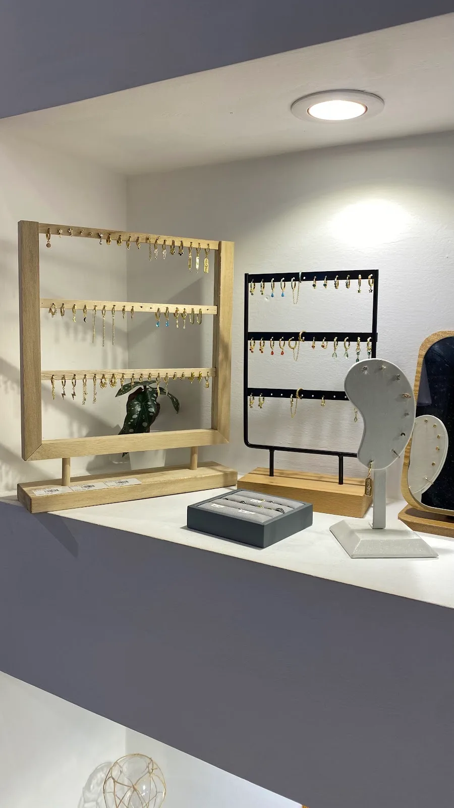 Earring display stands lined with gold and silver hoops and charms