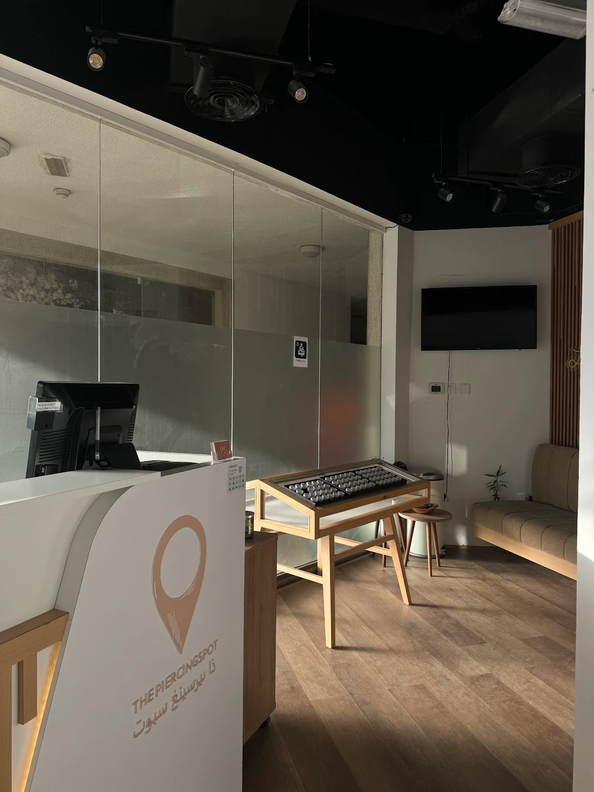 Reception and waiting area with display table and seating
