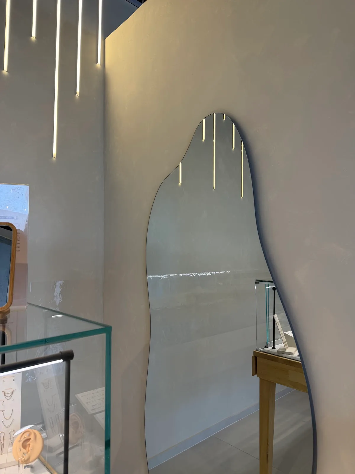 Soft-lit interior with a curved mirror and pendant lighting