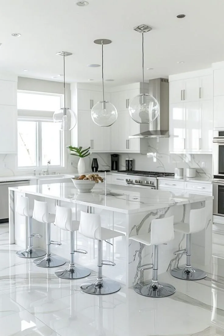 Modern white kitchen with marble waterfall island