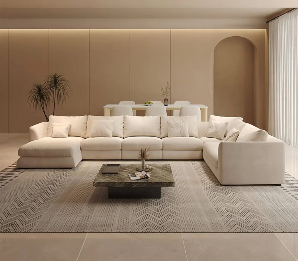 Large off-white modular sectional sofa on a patterned rug