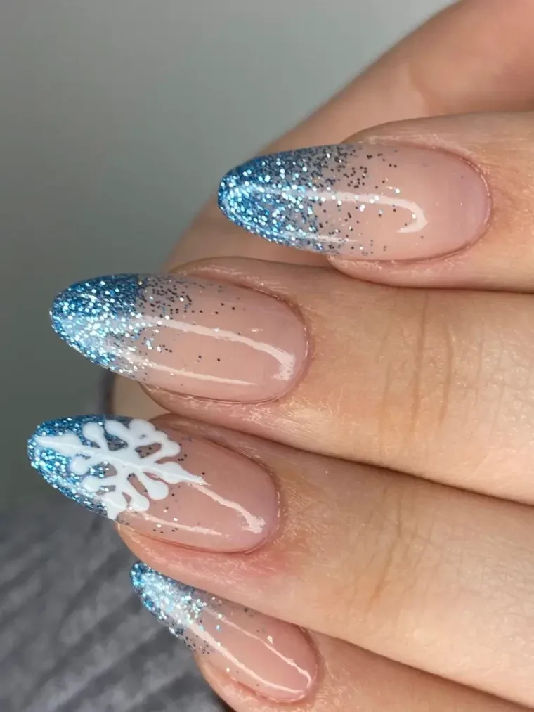 Blue glitter snowflake nail art