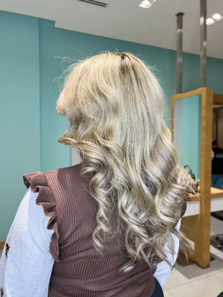 Blonde hair styled in soft curls