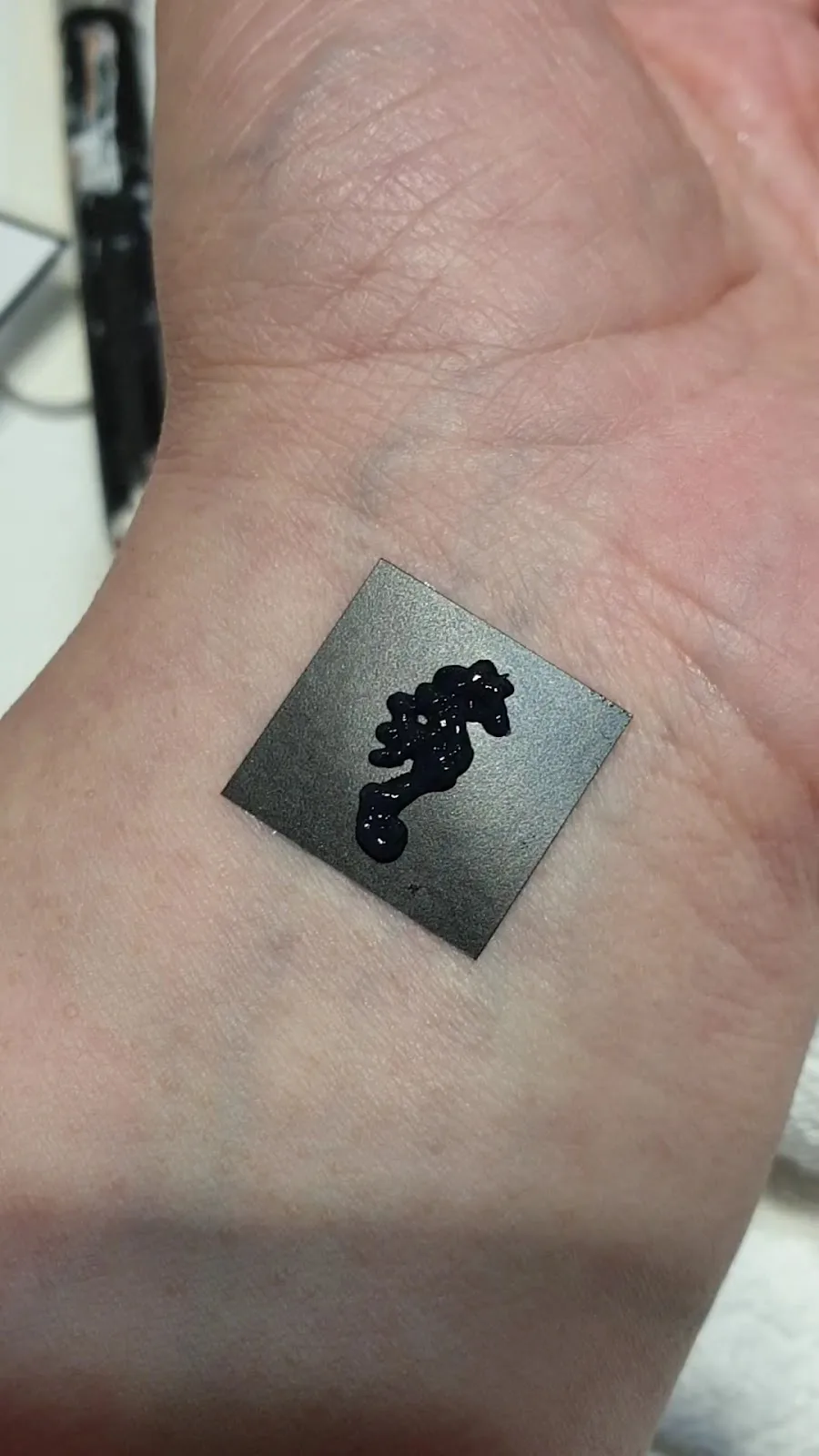 Henna seahorse design on wrist