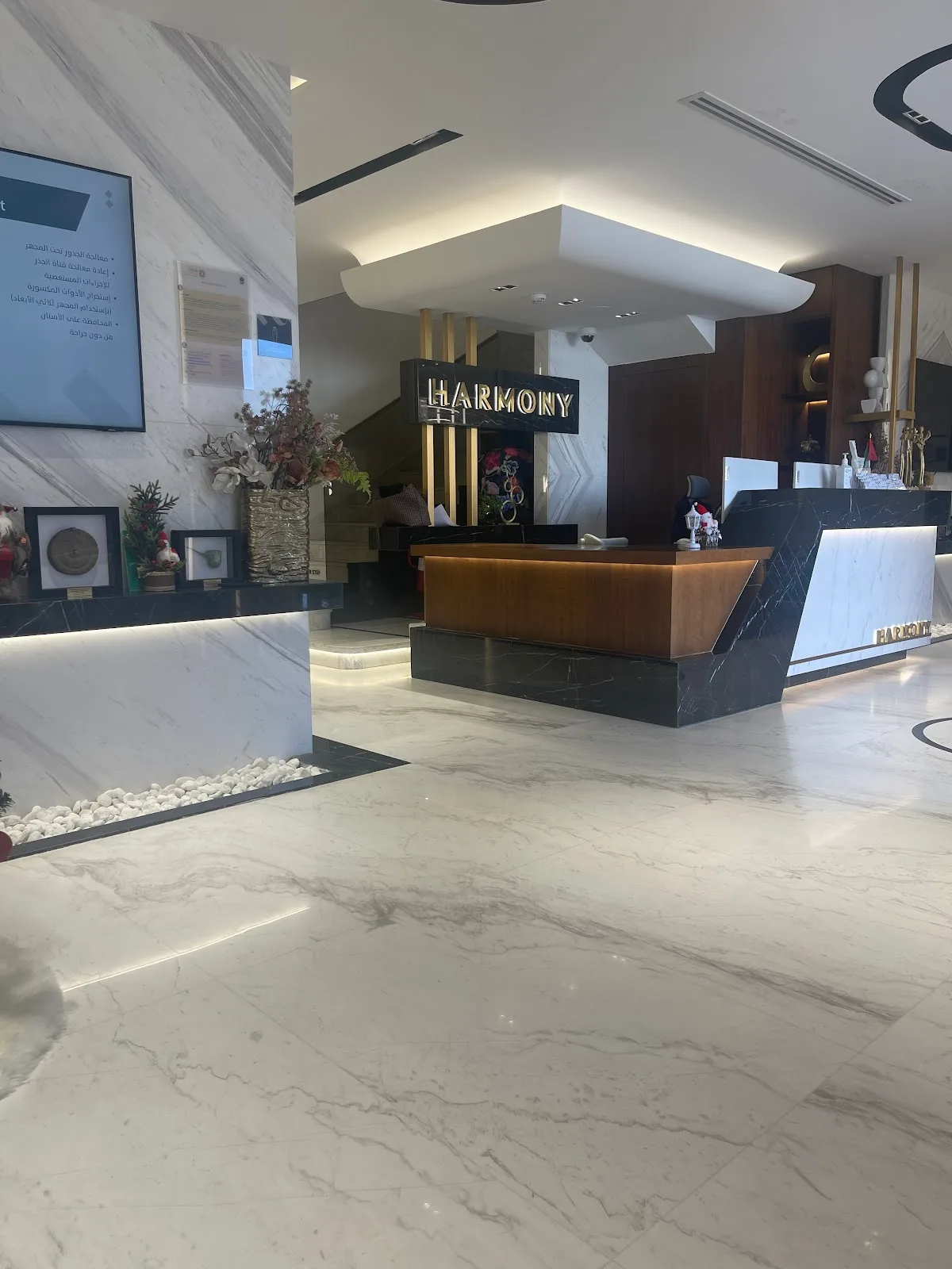 Reception desk with the Harmony sign in brass