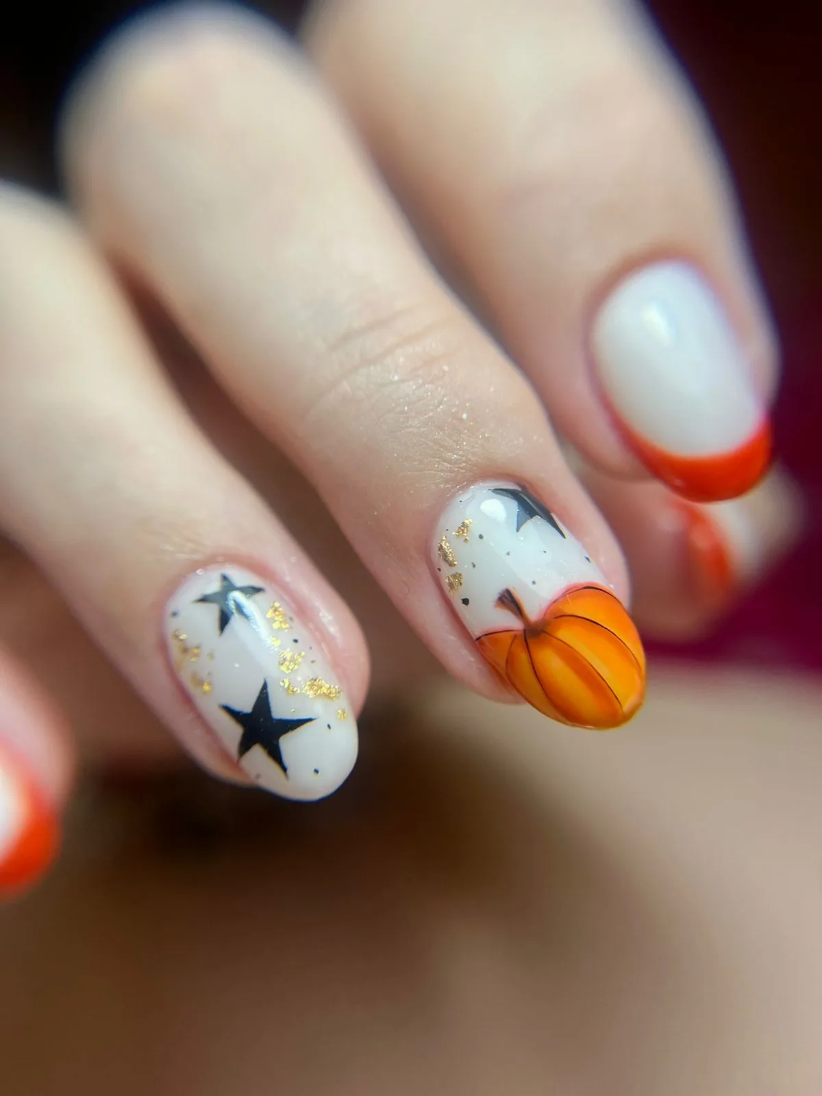 Seasonal pumpkin and star nail art