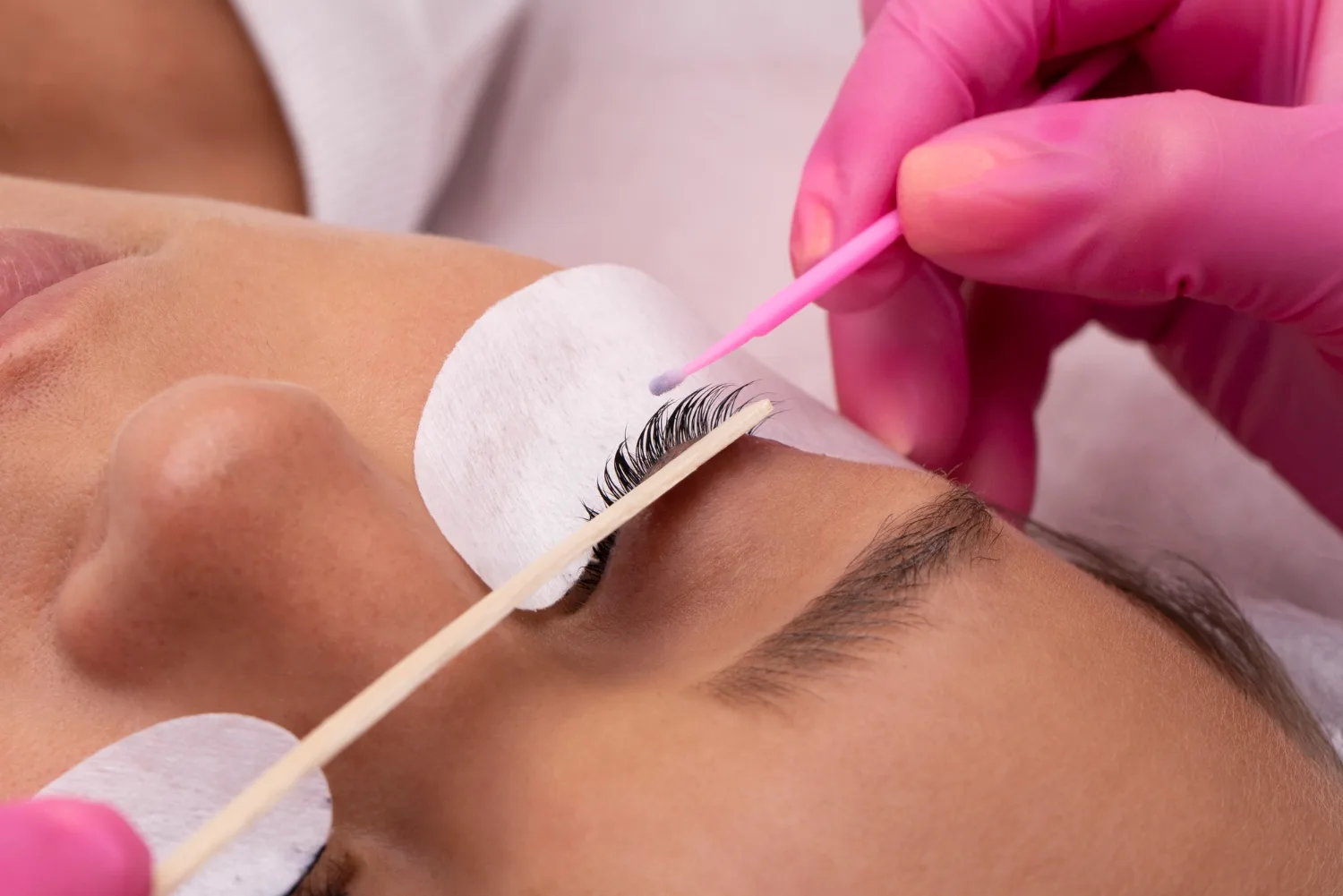 Eyelash extension treatment in progress