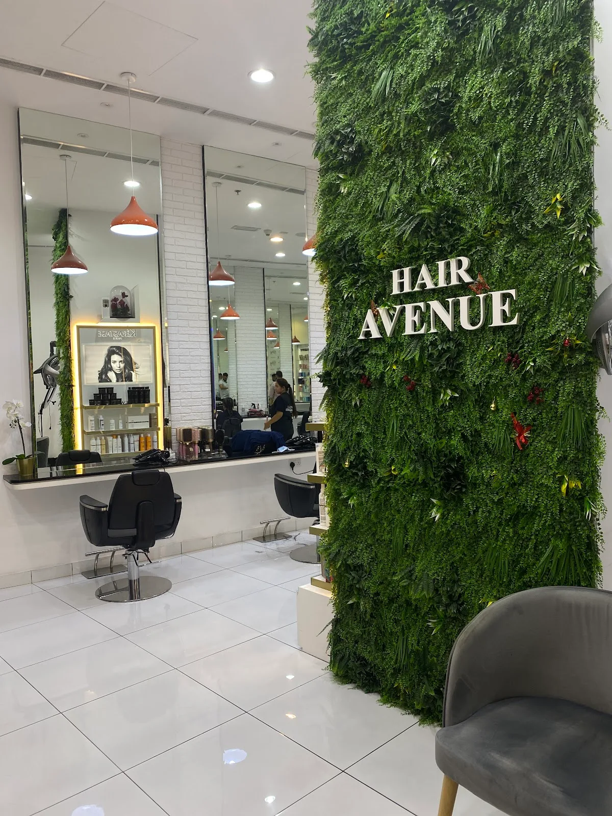 Hair Avenue salon interior with a living green wall and signage