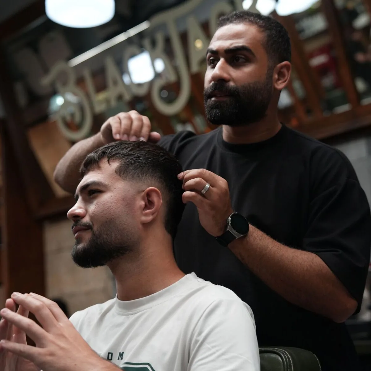 Barber working a clean fade at Black Jack Barber Shop