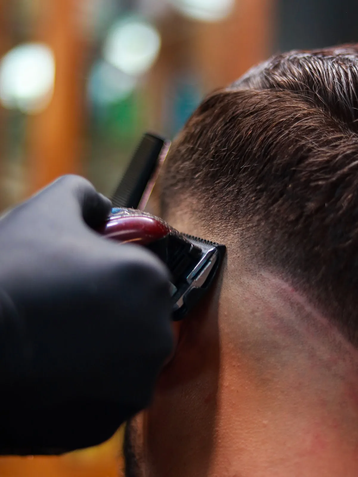 Barber finishing a clean neckline with a trimmer