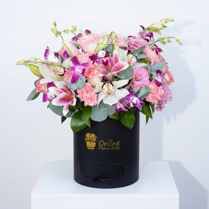 Pink lilies and roses in a signature black box