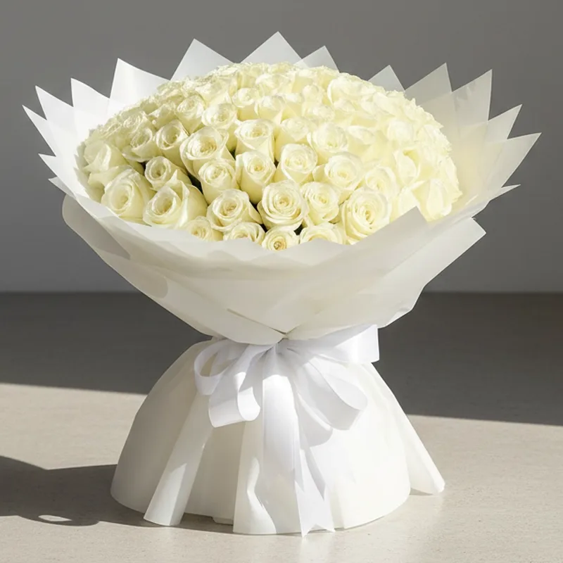 Large bouquet of white roses in cream wrapping