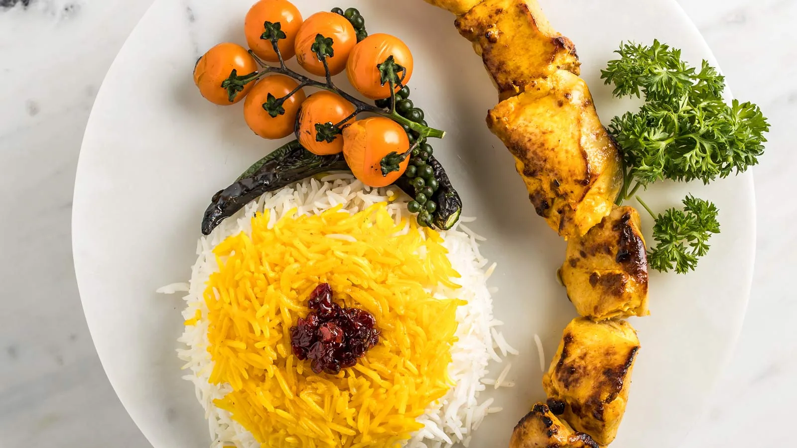 Saffron joojeh chicken kebab skewer with Persian saffron and steamed rice