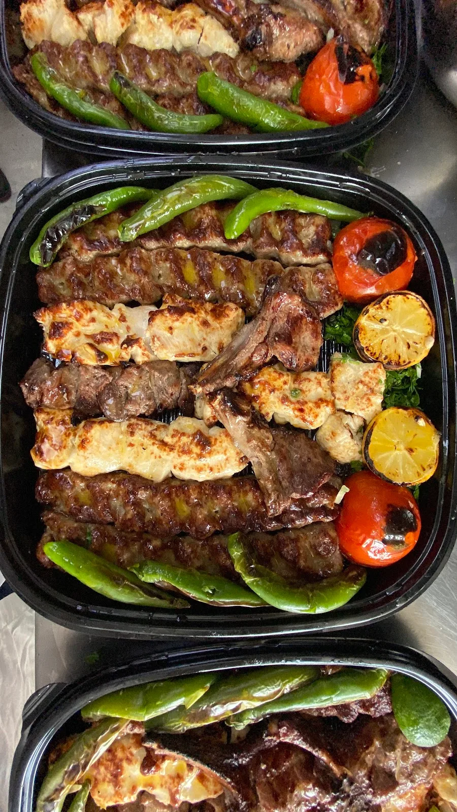 Mixed grill catering boxes with kebabs and grilled peppers