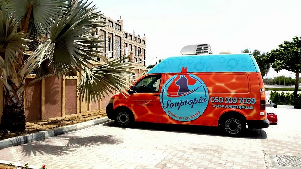 The Soaptopia Dubai branded mobile pet grooming van parked outside a villa