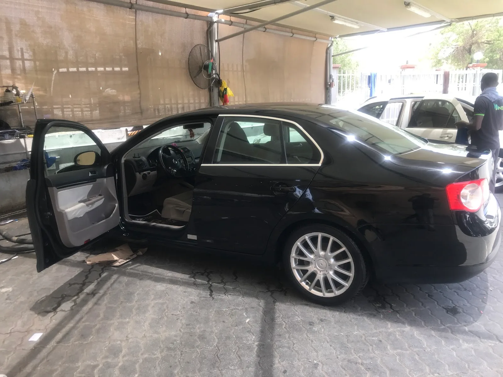 Sedan being washed under the covered bay