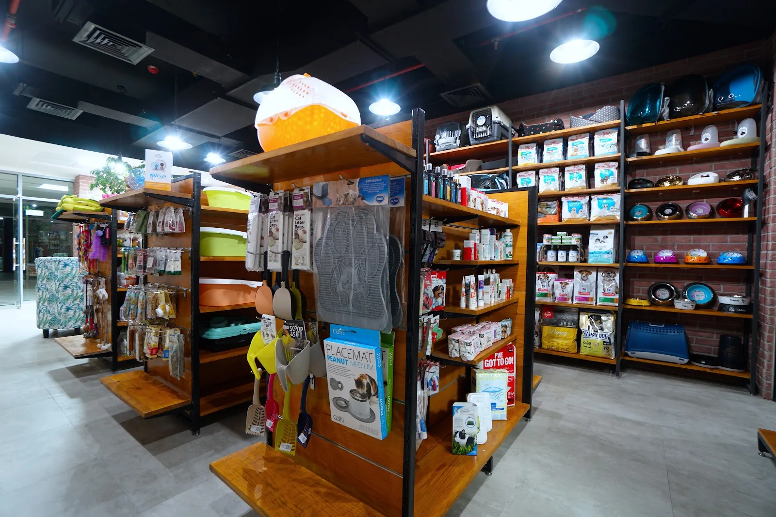 Pet boutique shelves stocked with food, toys and accessories