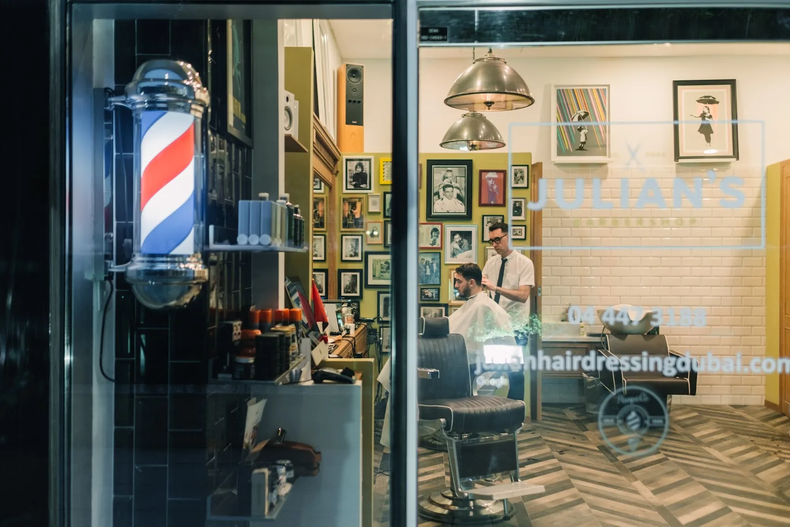 Storefront at night with barber pole