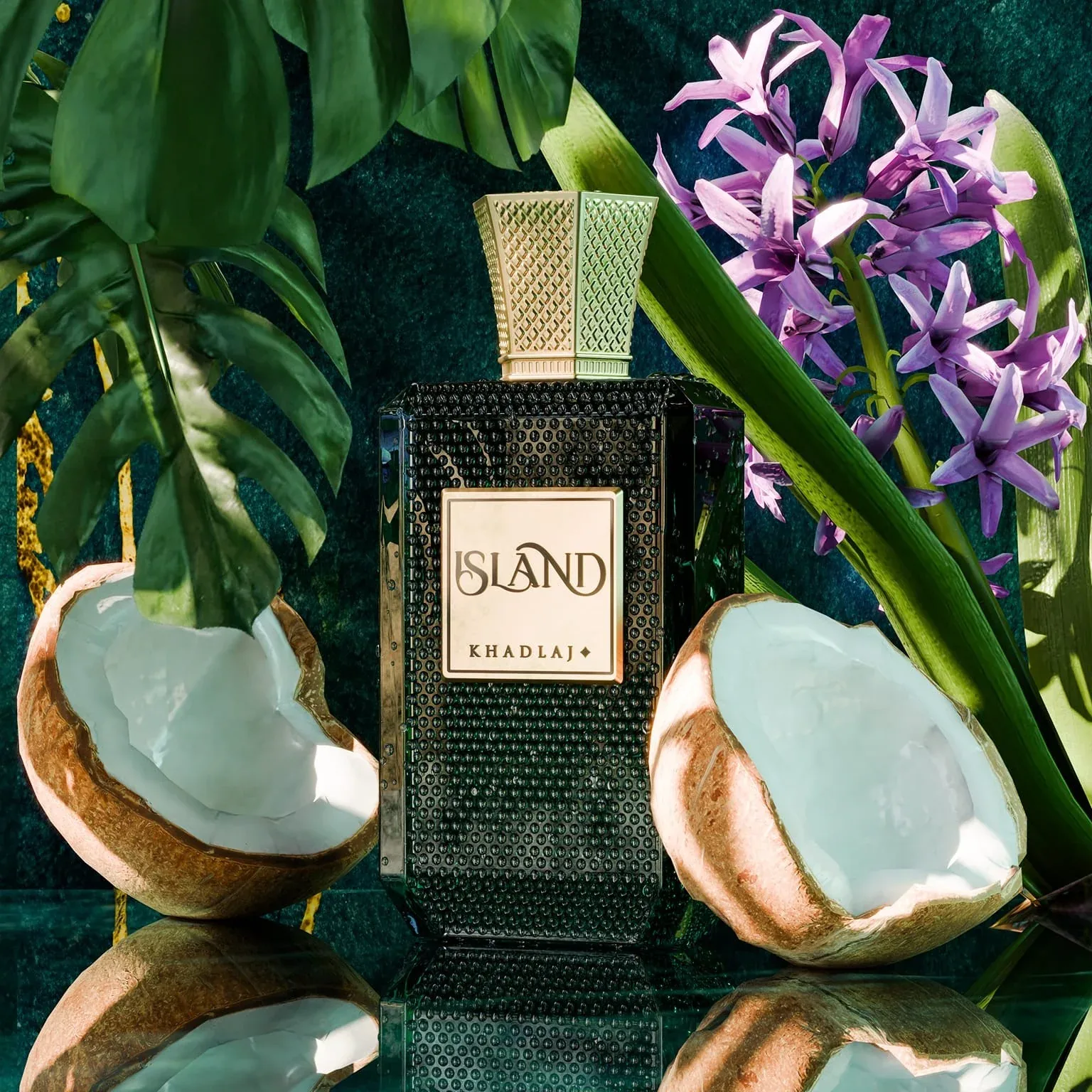 Khadlaj Island — a black studded bottle styled with coconut and tropical leaves
