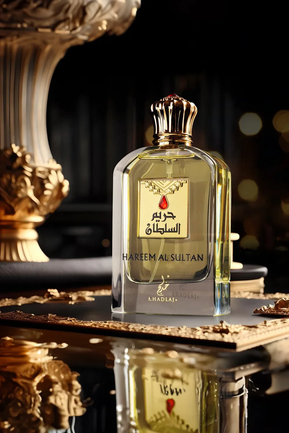 A Khadlaj clear-glass perfume bottle with a gold crown cap, photographed in a warm, dark luxury setting