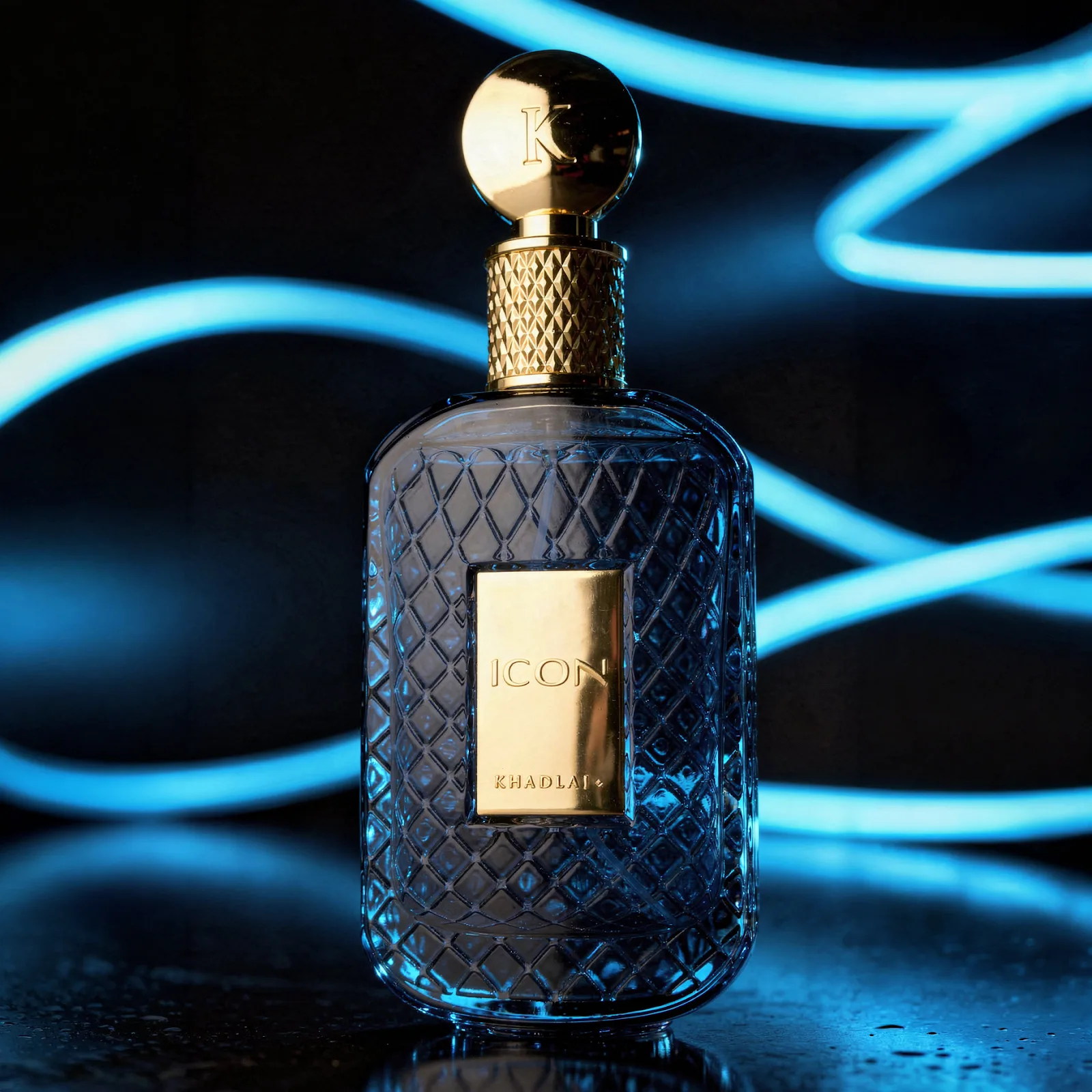 Khadlaj Icon — a faceted blue-glass perfume bottle with a gold cap against neon light